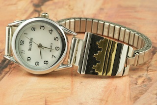 Beautiful Sterling Silver Watch Tips with Gold Fill Pueblo Design. Ladies quartz watch with expandable band. Created by Navajo Artist Tommy Singer. Signed.